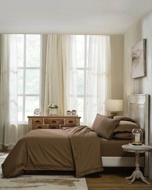 Baked Clay 400TC percale duvet cover with flange, side view on a made bed