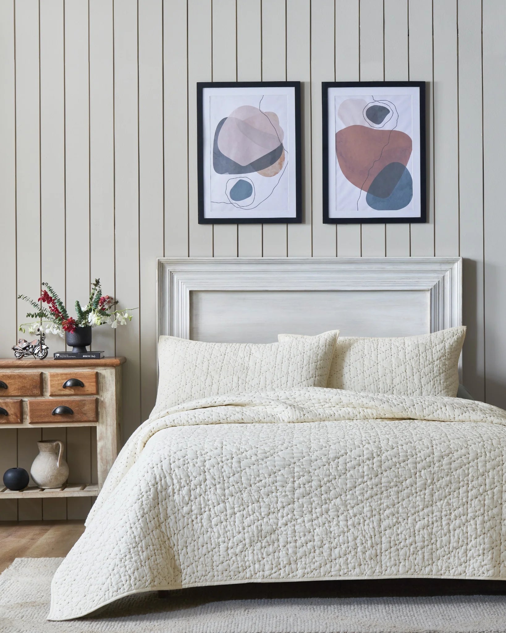 Buttercream organic tri-color stitch hand quilt set with king pillow covers, front view on a made bed