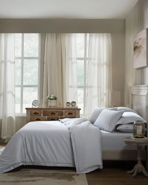 Cool Grey 600TC sateen duvet cover with flange, side view on a made bed