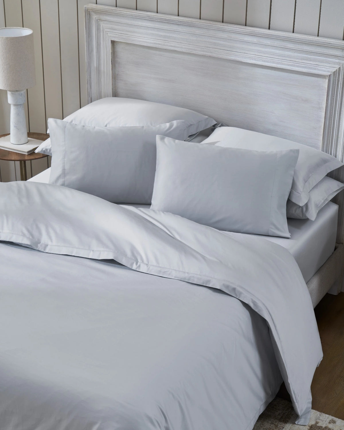 Cool Grey 600TC sateen duvet cover with flange, top view on a made bed