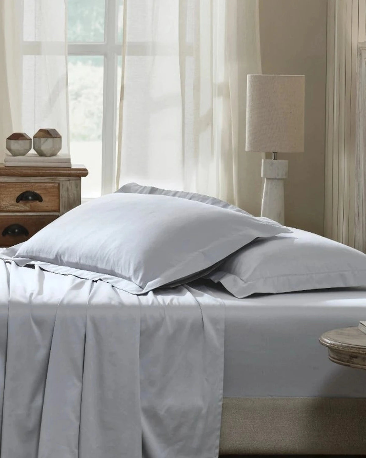 Cool Grey 600TC sateen king pillow cover set with flange, side view on a made bed