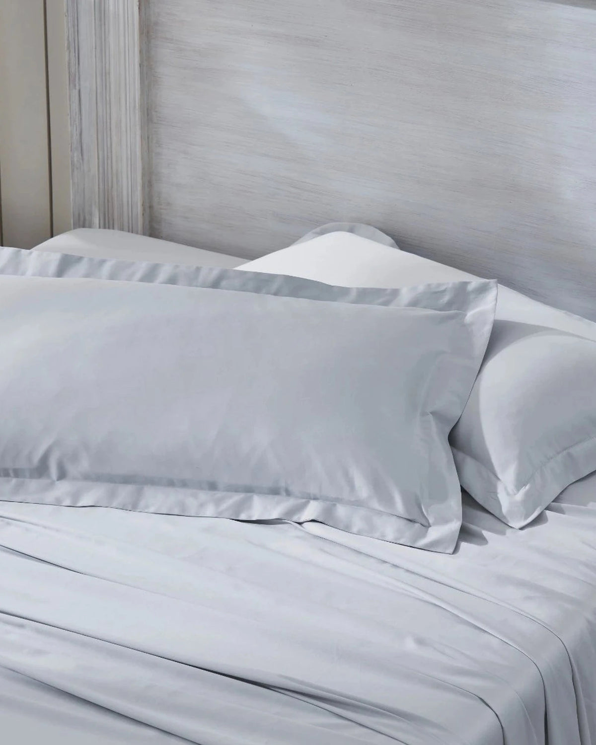 Cool Grey 600TC sateen king pillow cover set with flange, top view on a made bed
