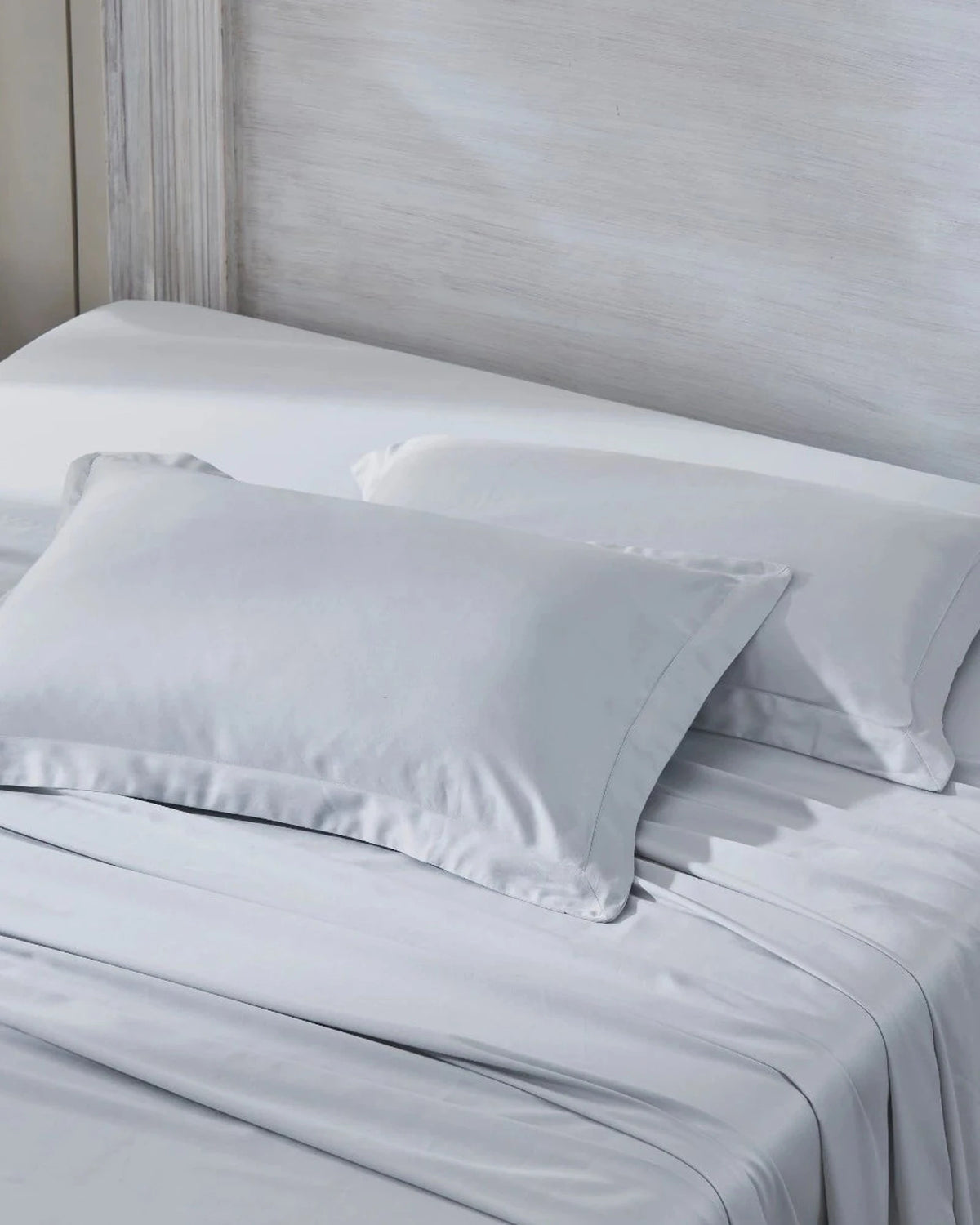 Cool Grey 600TC sateen standard pillow cover set with flange, top view on a made bed