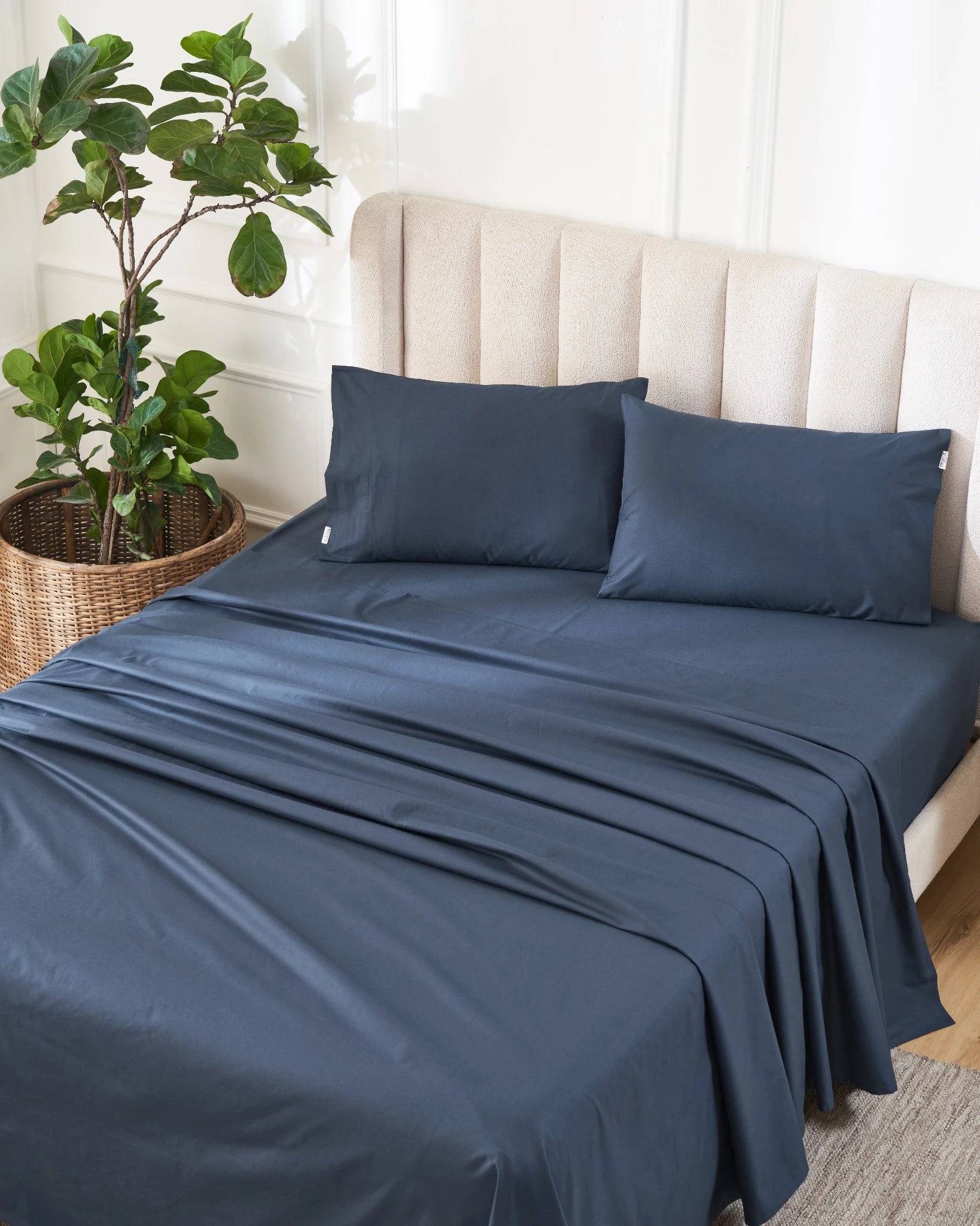 Dress Blue 400TC percale flat sheet set with standard pillow covers, styled on a bed in a bright bedroom