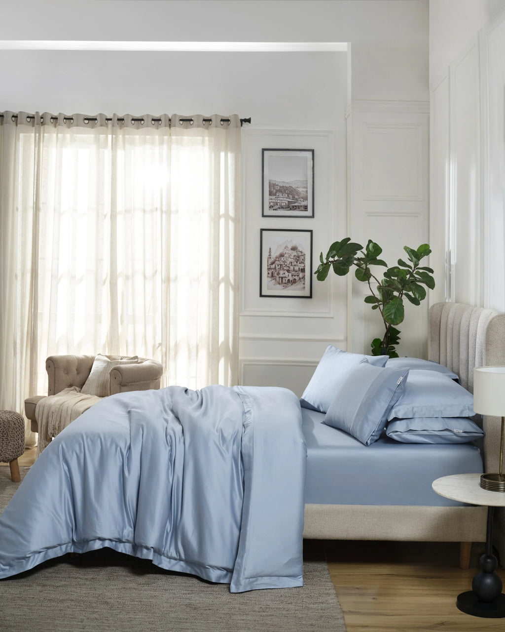 Dusty Blue 600TC sateen duvet cover with flange, side view on a made bed