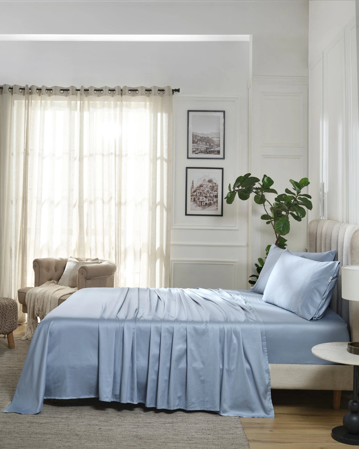 Dusty Blue 600TC sateen flat sheet set with king pillow covers, side view on a made bed