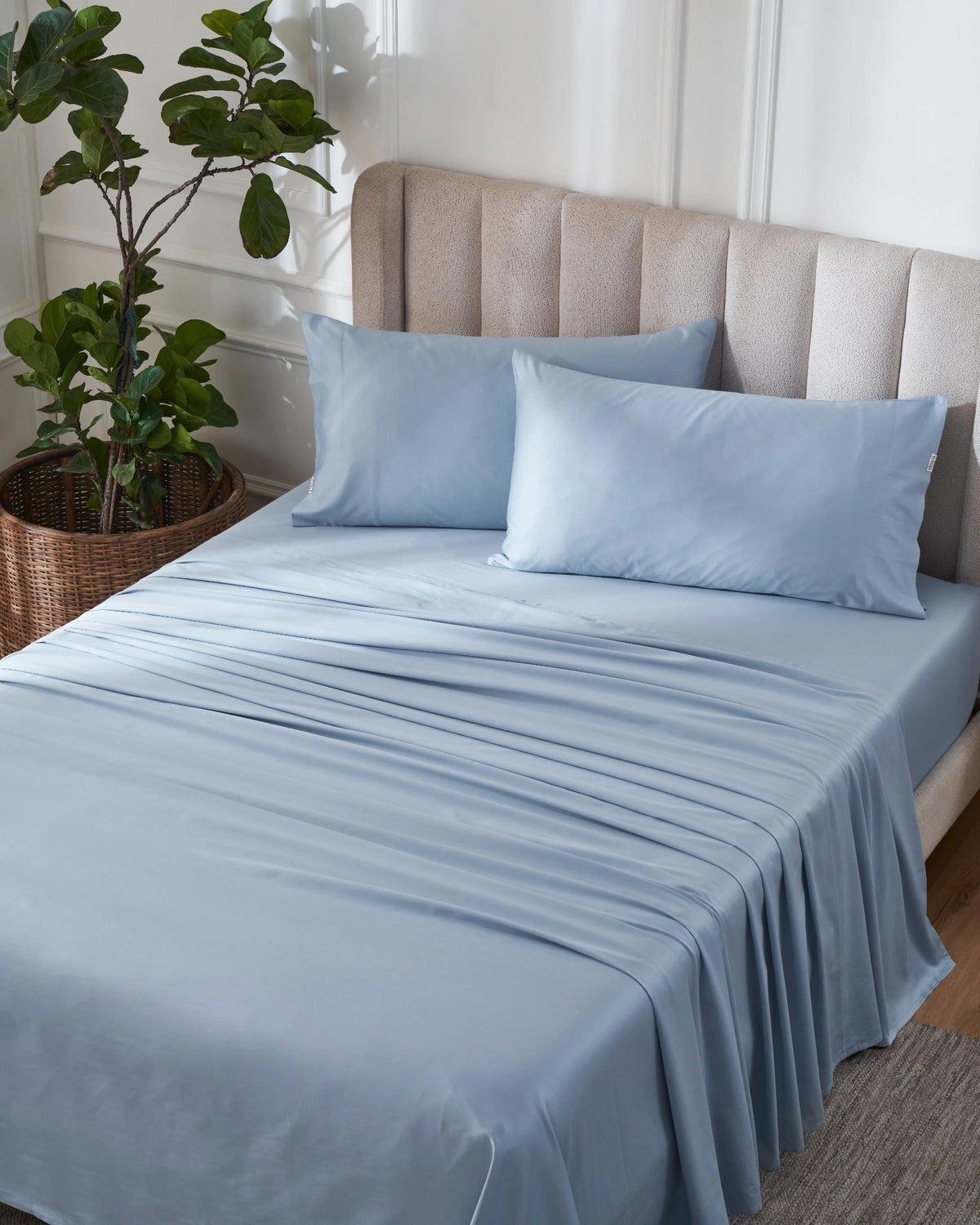 Dusty Blue 600TC sateen flat sheet set with king pillow covers, top view on a made bed