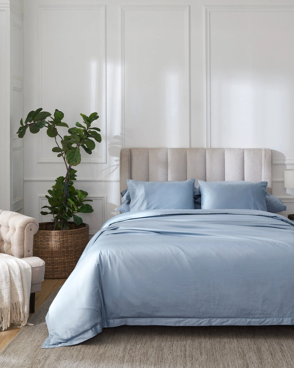 Dusty Blue 600TC sateen duvet cover with flange, front view on a made bed