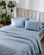 Dusty Blue 600TC sateen duvet cover with flange, top view on a made bed