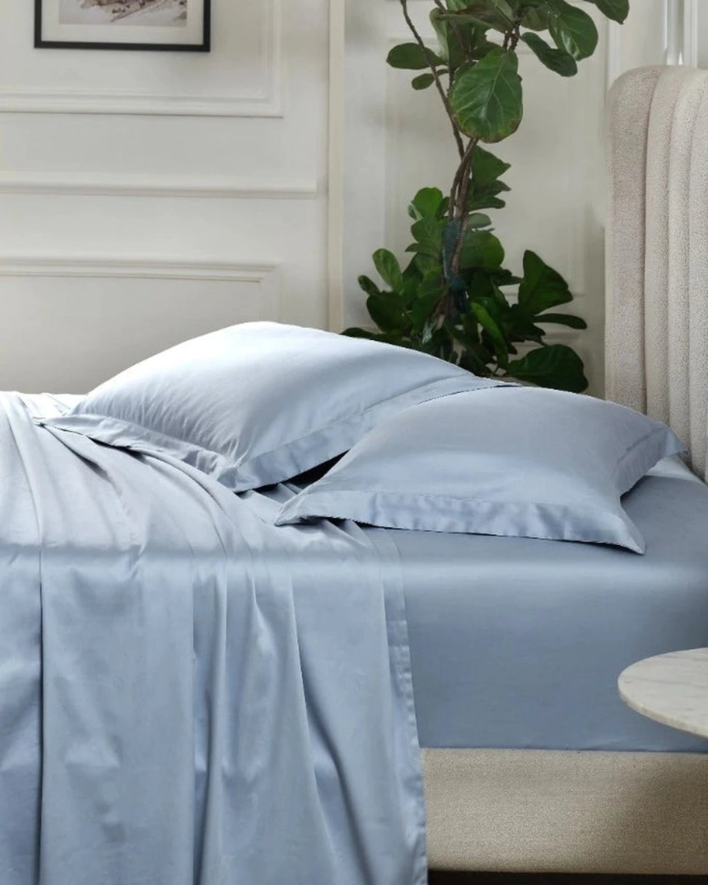 Dusty Blue 600TC sateen standard pillow cover set with flange, side view on a made bed