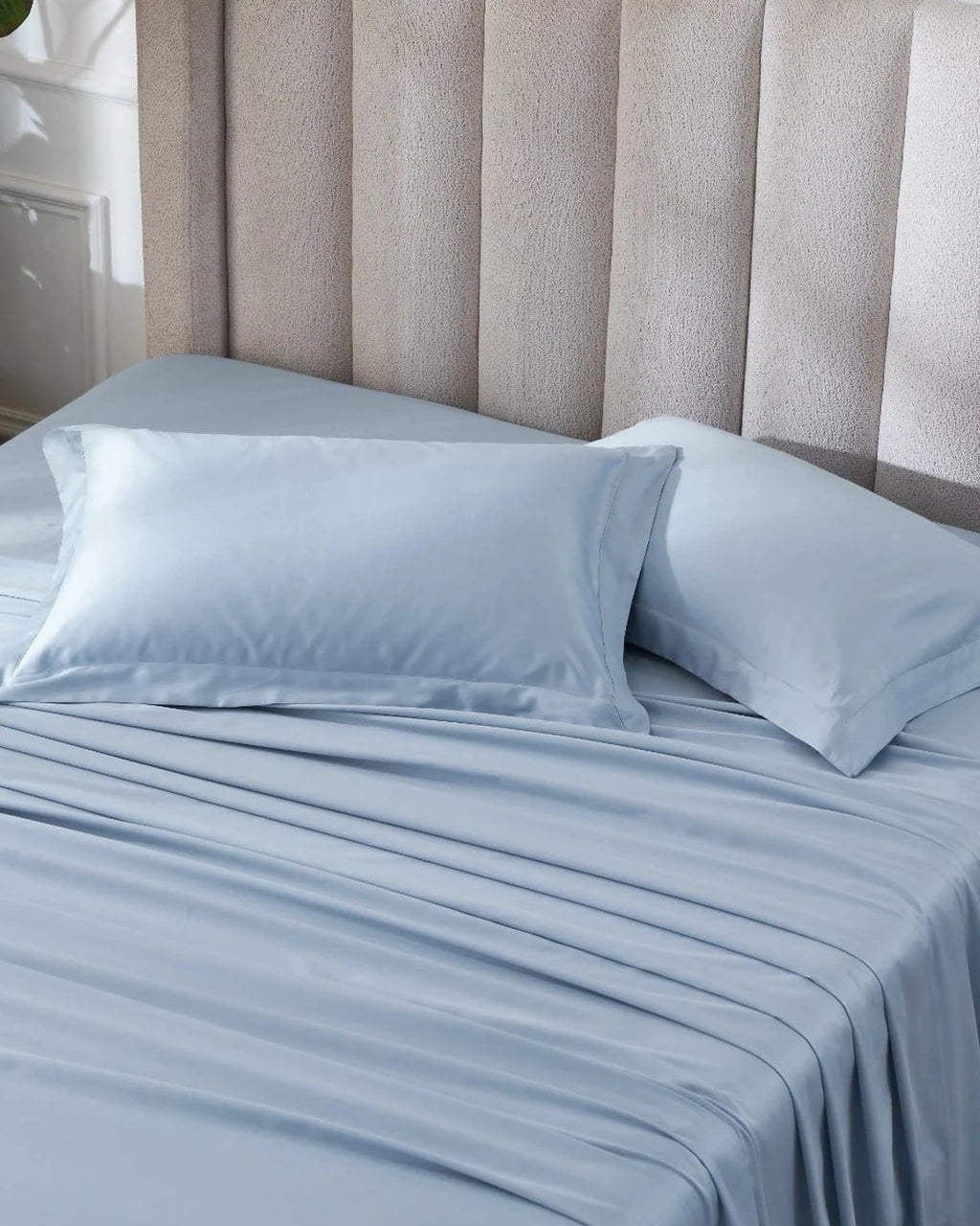 Dusty Blue 600TC sateen standard pillow cover set with flange, top view on a made bed