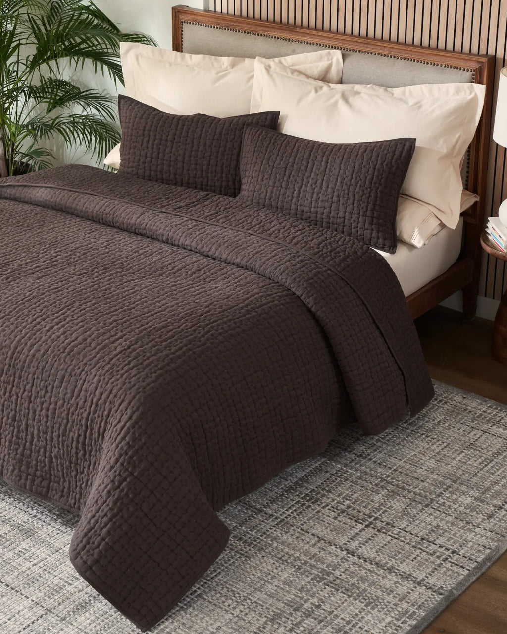Espresso European linen box-stitch hand quilt set with standard pillow covers, top view on a made bed