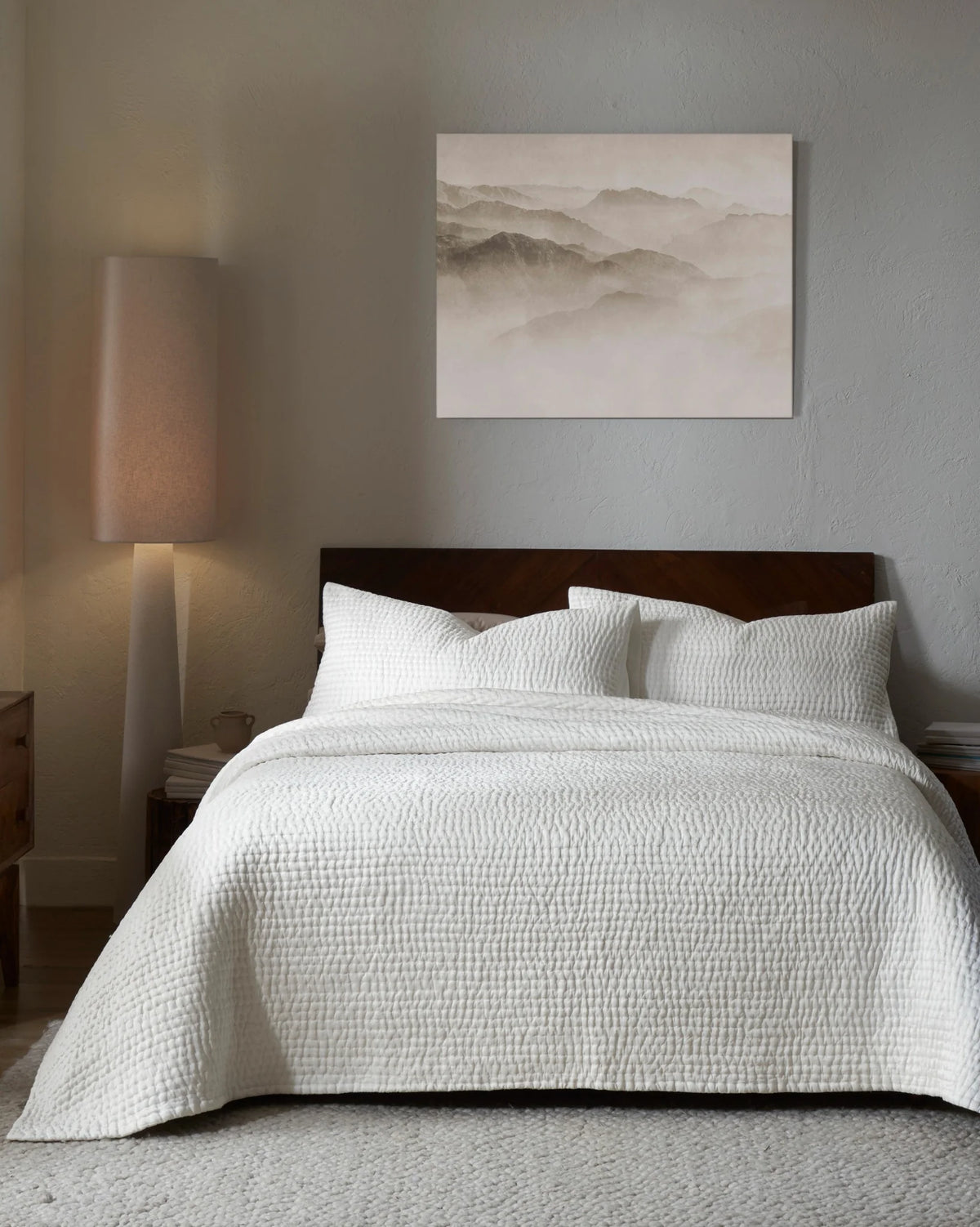 Ivory habutai silk hand-quilted quilt set with king pillowcases, front view on a made bed