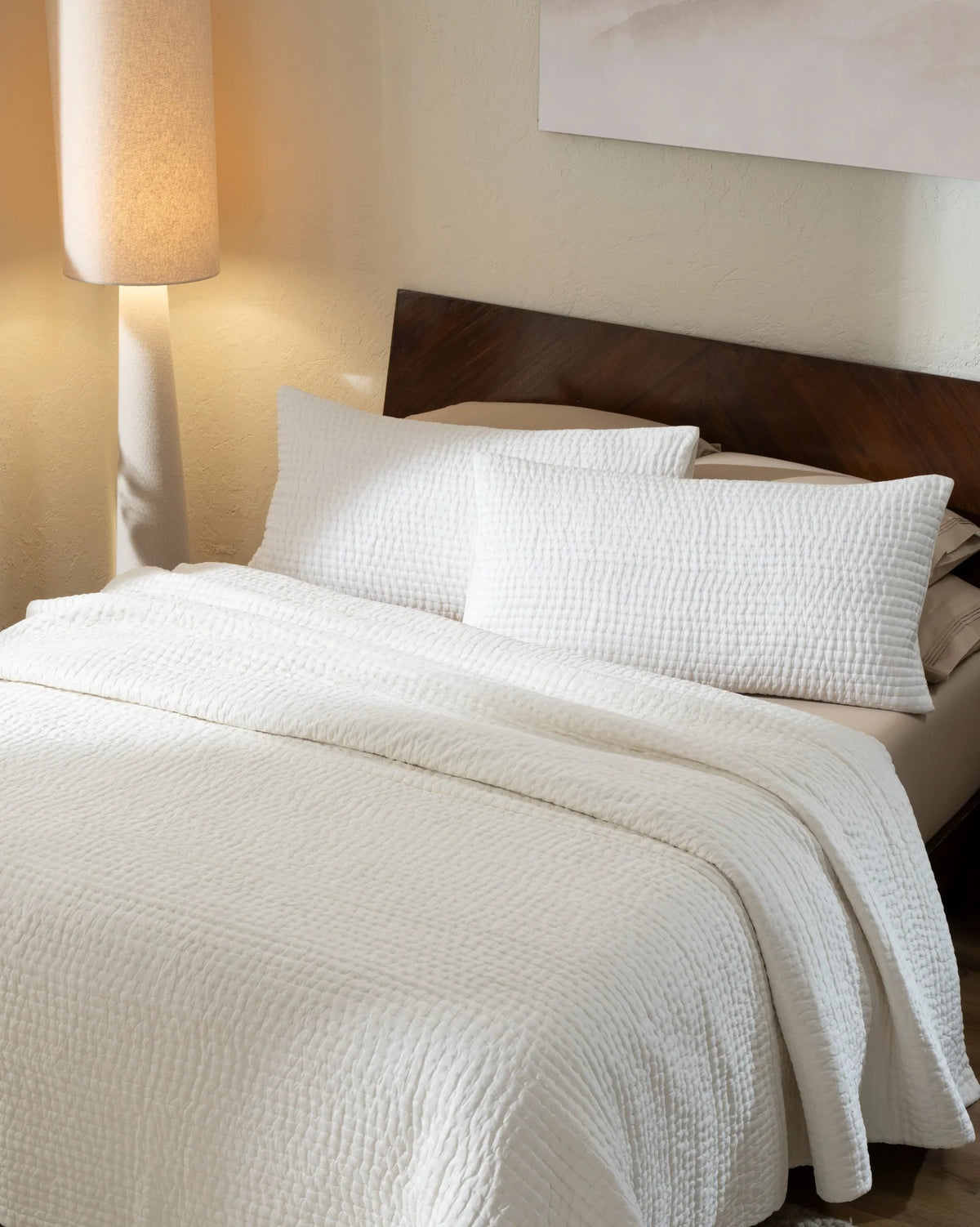 Ivory habutai silk hand-quilted quilt set with king pillowcases, top view on a made bed