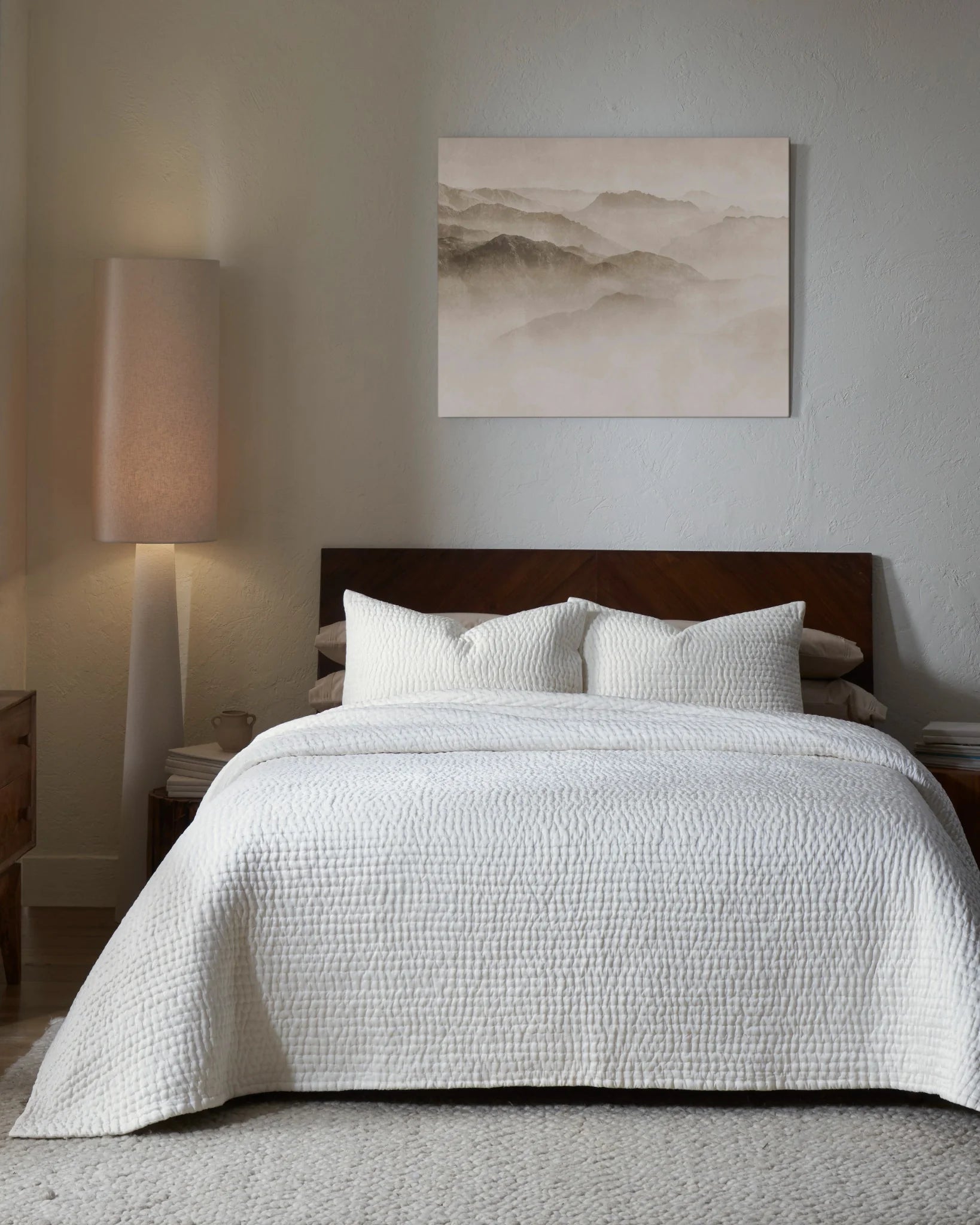 Ivory habutai silk hand-quilted quilt set with standard pillow covers, front view on a made bed