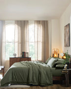 Ivy Green 400TC percale duvet cover with flange, side view on a made bed