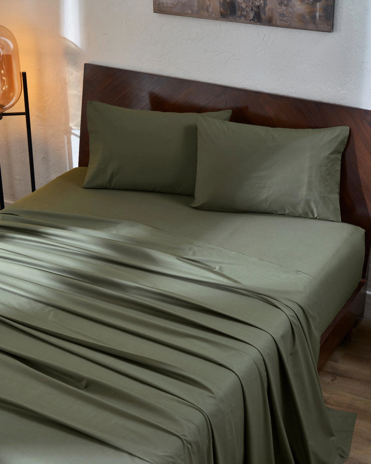 Ivy Green 400TC percale flat sheet set with standard pillow covers, top view on a made bed