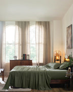 Ivy Green 400TC percale standard pillow cover set with flange, side view on a made bed