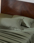 Ivy Green 400TC percale standard pillow cover set with flange, top view on a made bed