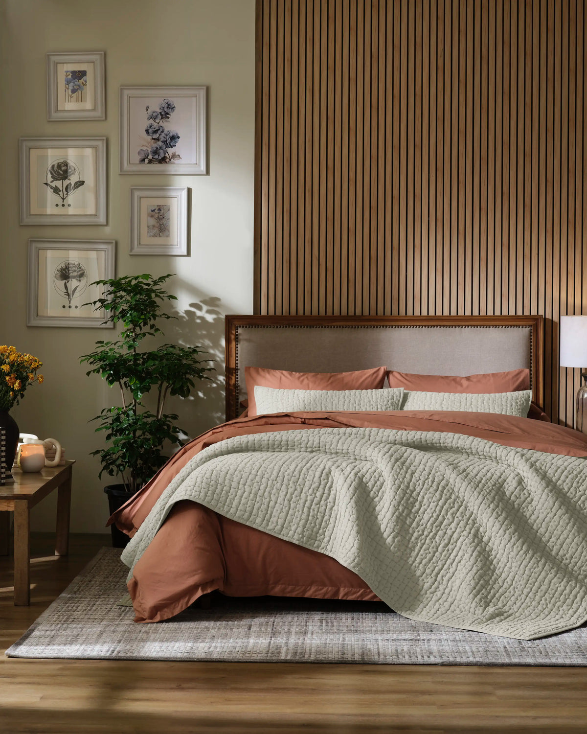 Natural European linen box-stitch hand quilt set with standard pillow covers, front view on a made bed