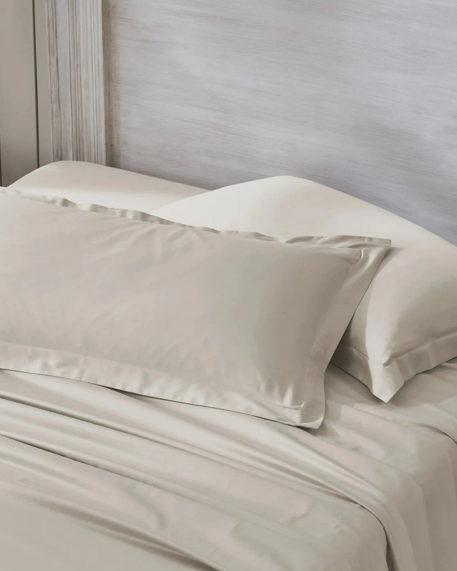 Oatmilk 600TC sateen king pillow cover set with flange, top view on a made bed