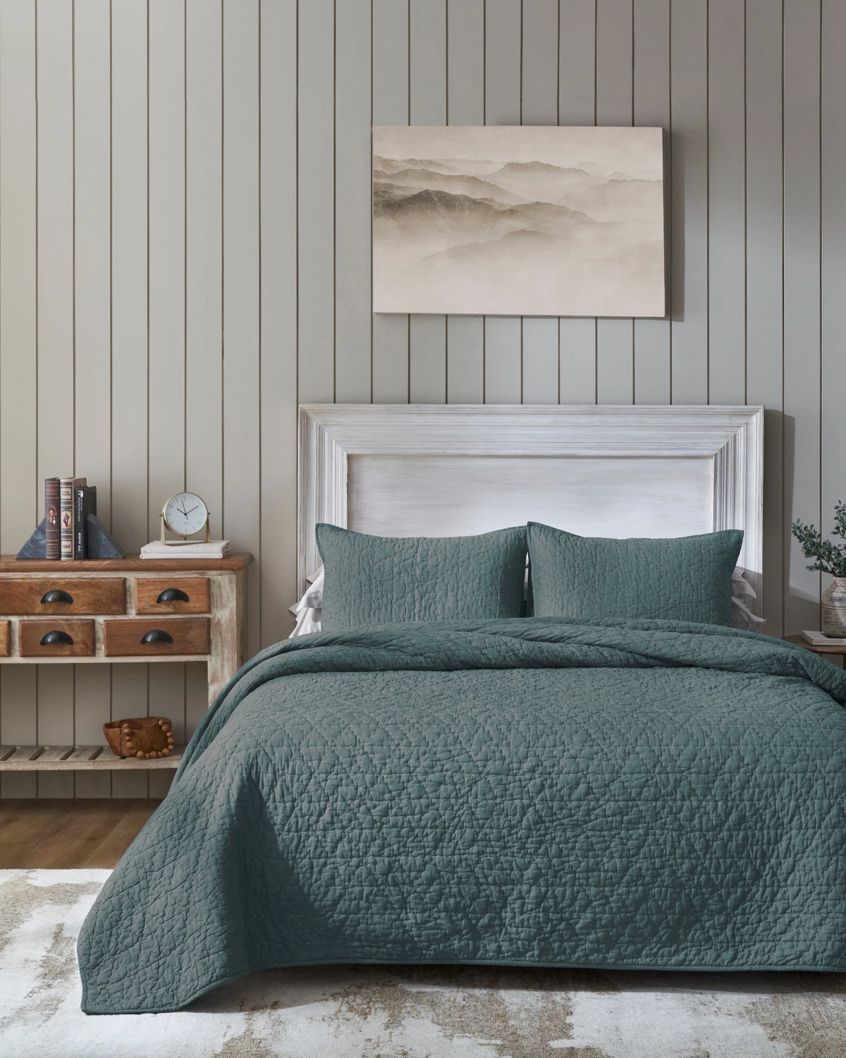 Ocean organic tri-color stitch hand quilt set with standard pillow covers, front view on a made bed