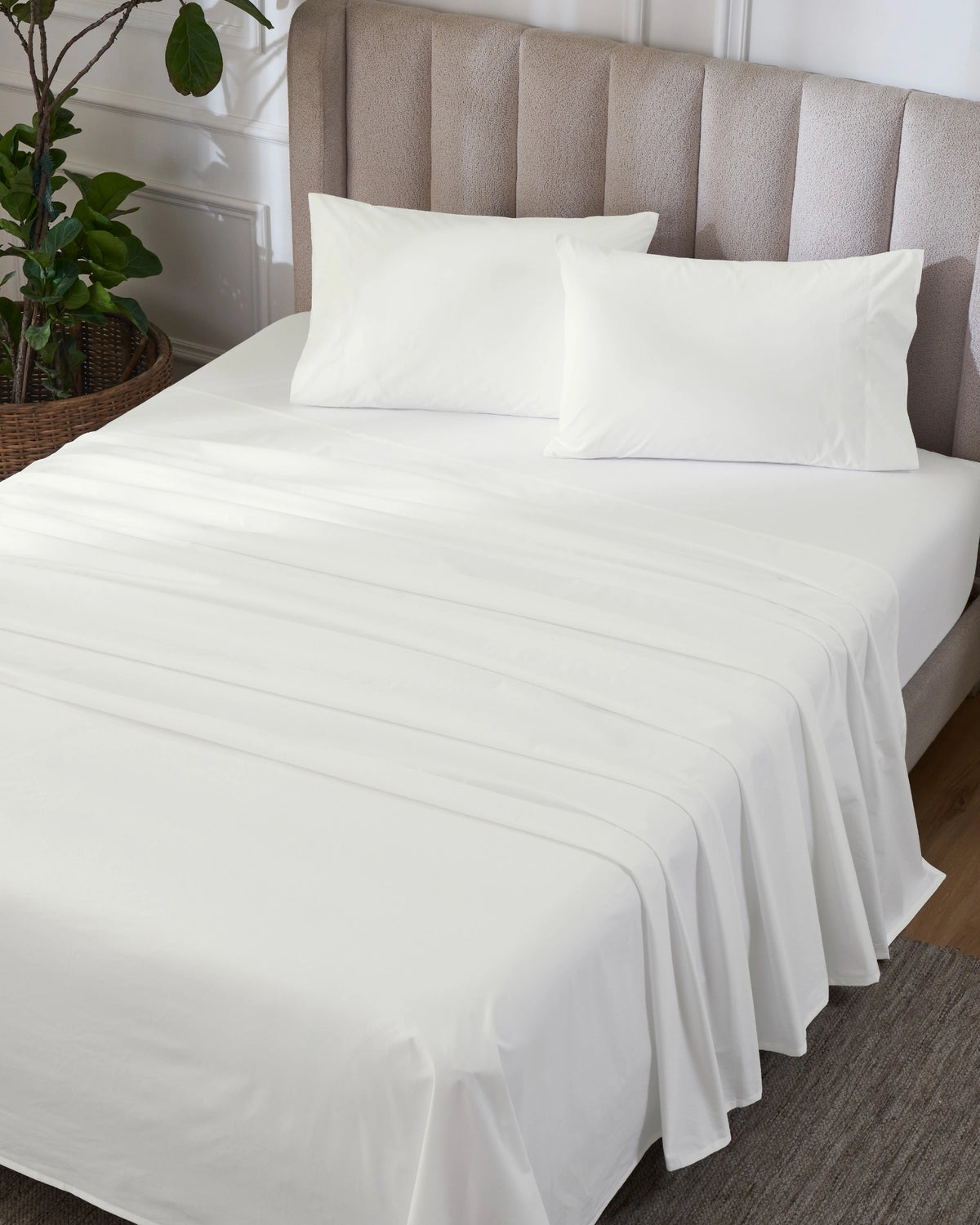 Optic White 400TC percale flat sheet set with standard pillowcases, top view on a made bed