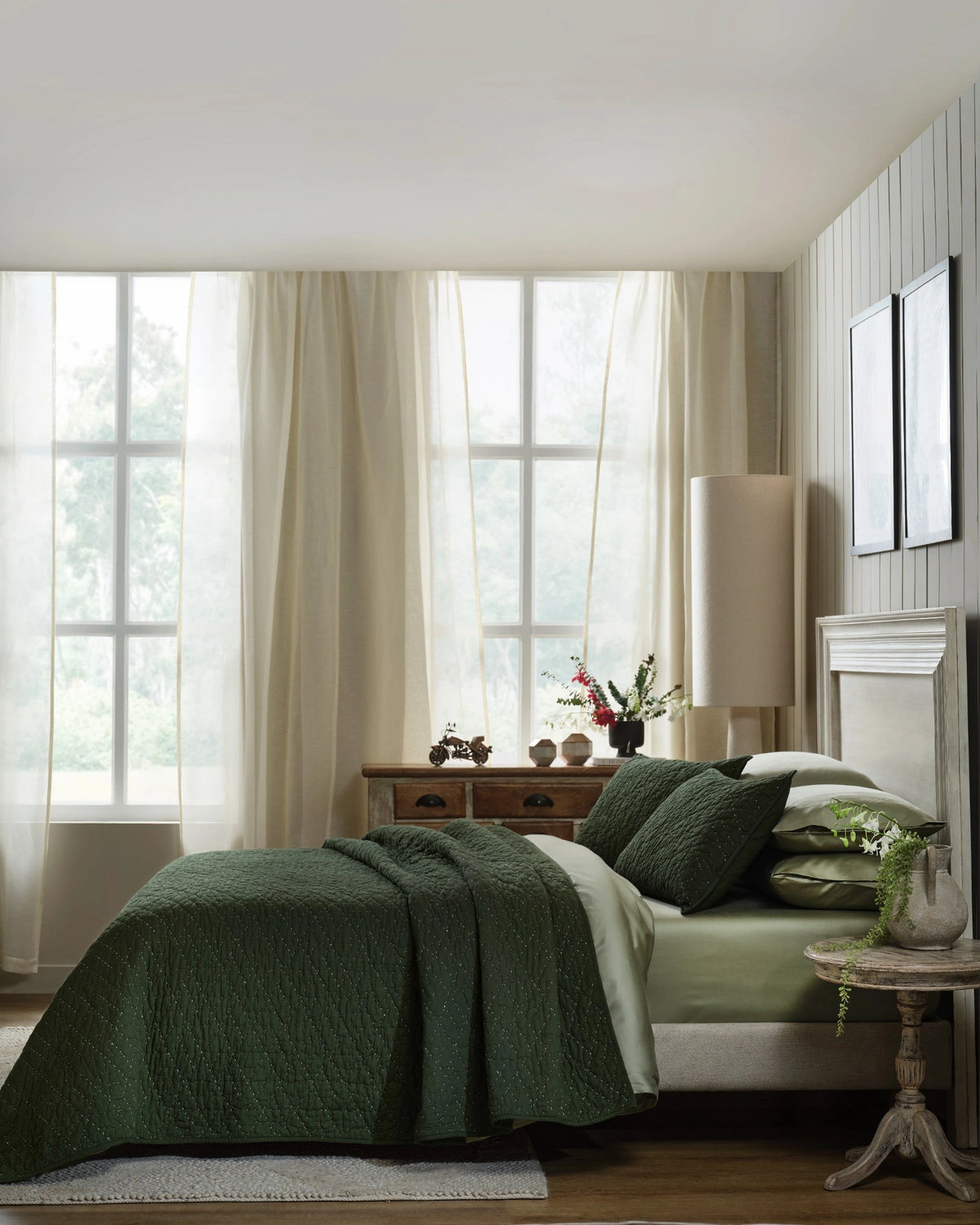Pine organic tri-color stitch hand quilt set with standard pillowcases, side view on a made bed