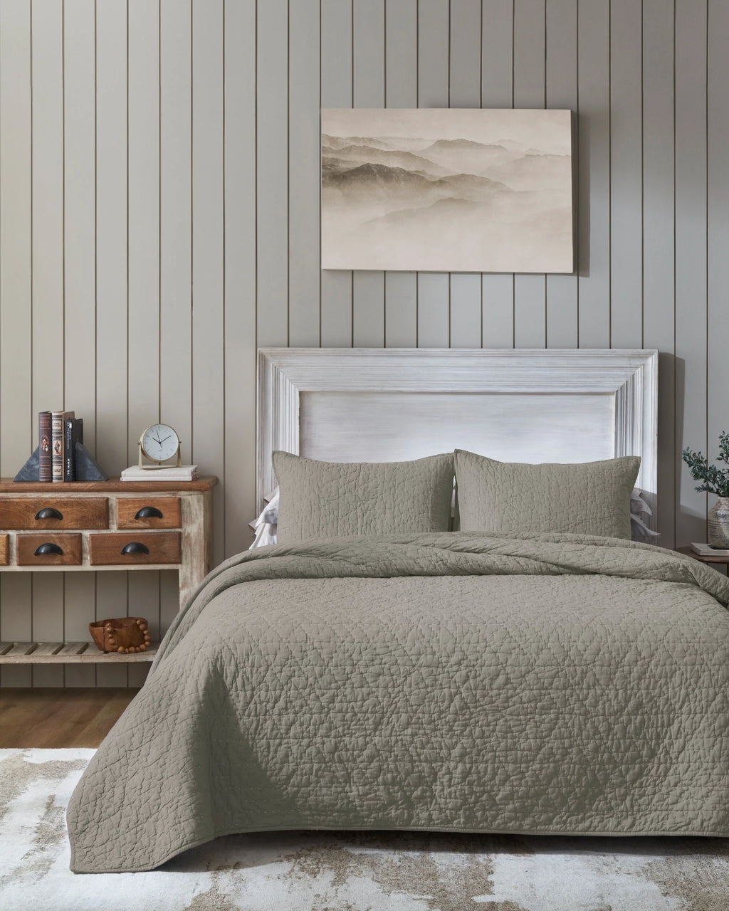 Stone organic tri-color stitch hand quilt set with standard pillow covers, front view on a made bed