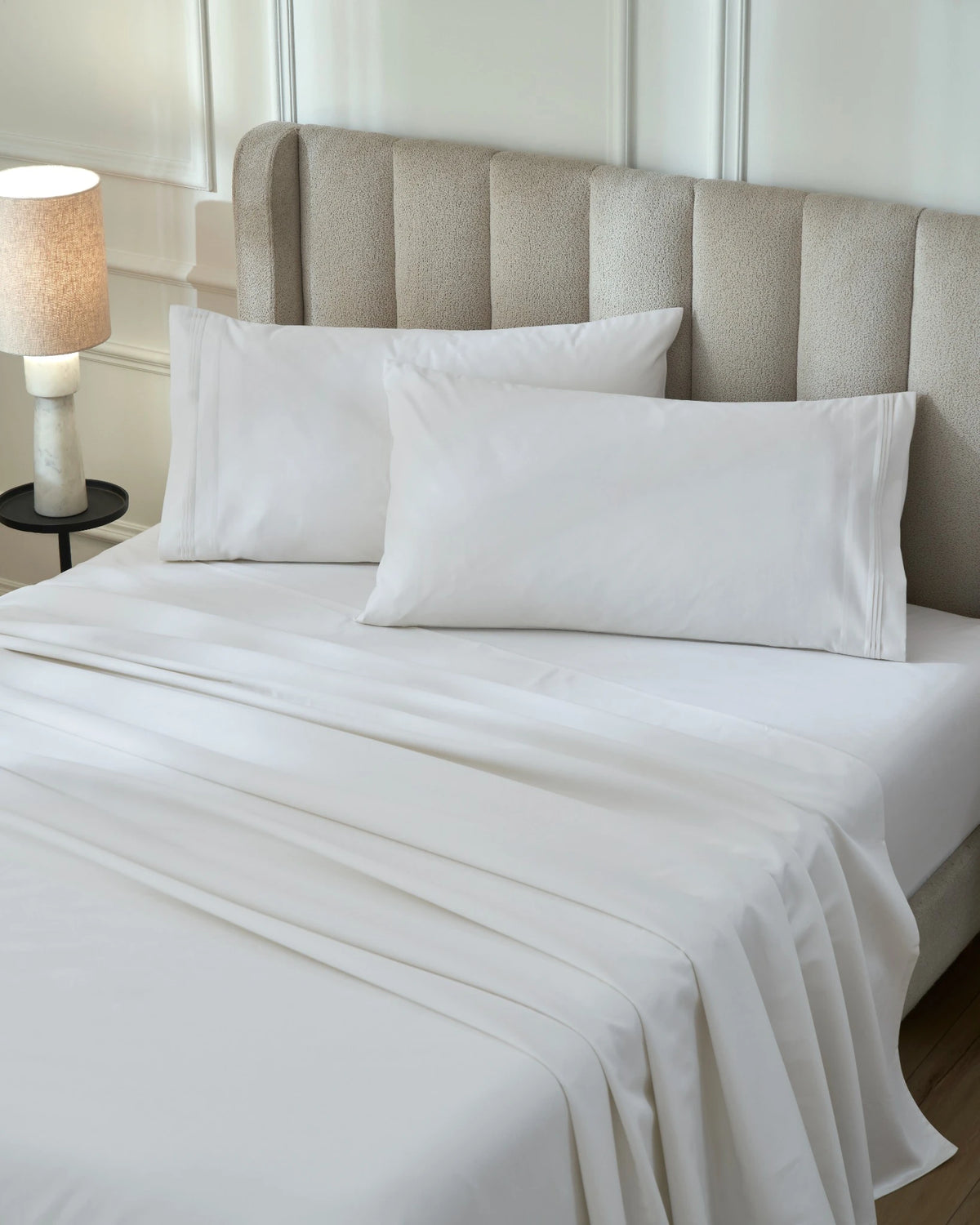Tofu 1000TC sateen flat and fitted sheet set with king pillow covers, top view on a made bed