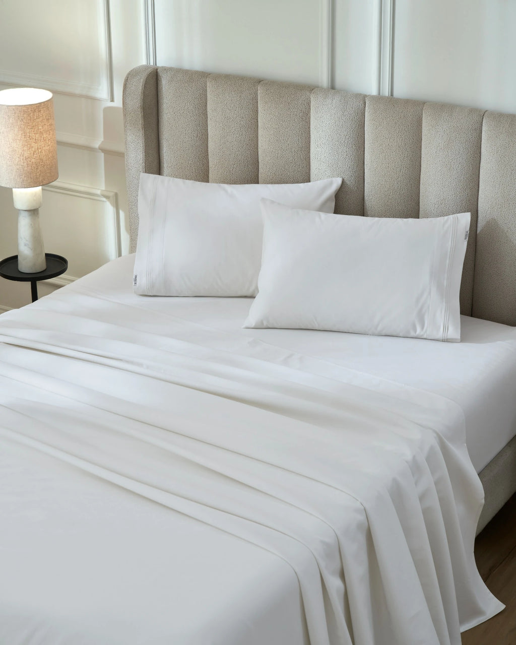 Tofu 1000TC sateen flat and fitted sheet set with standard pillow covers, top view on a made bed