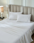 Tofu 1000TC sateen flat and fitted sheet set with standard pillow covers, top view on a made bed
