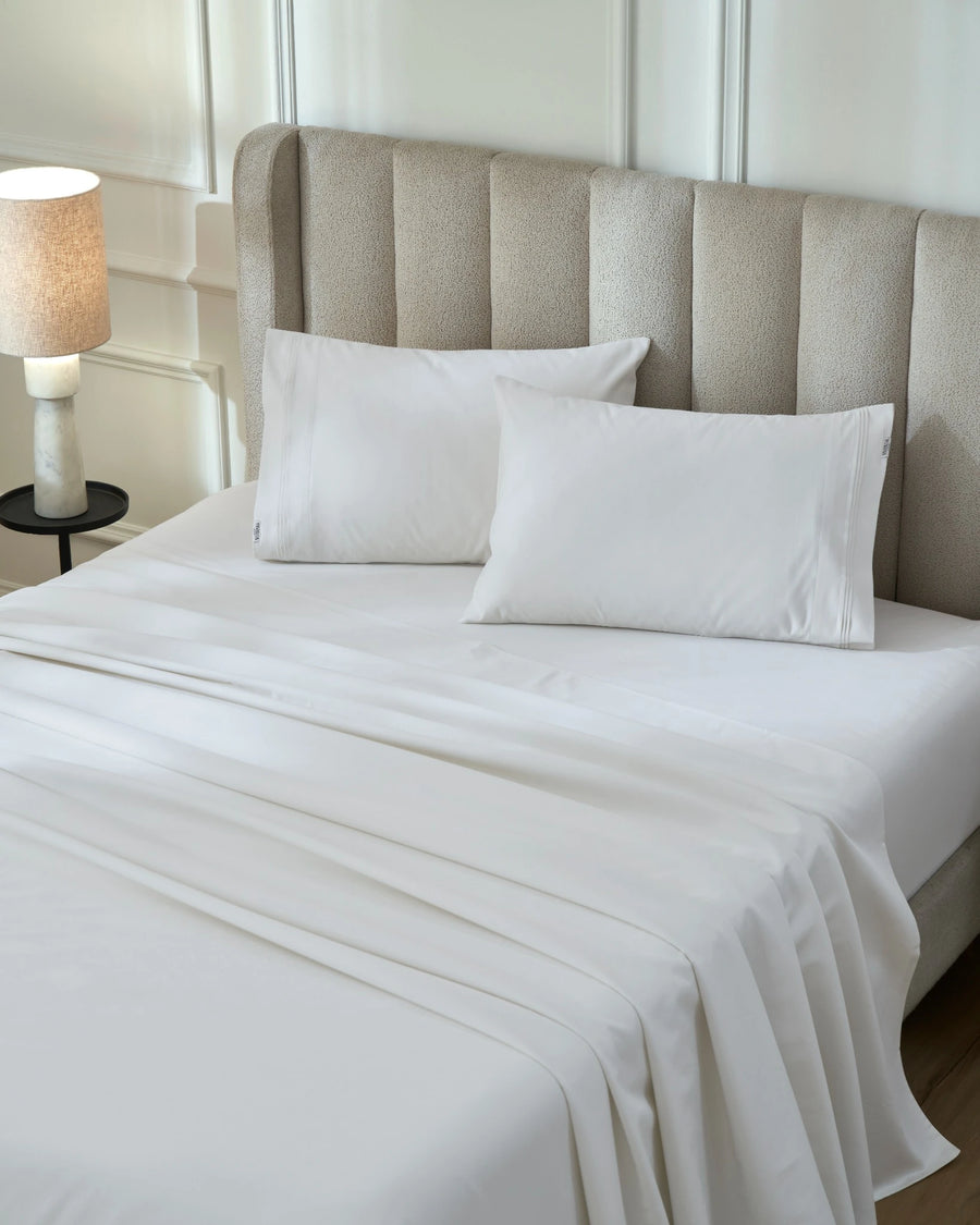 Tofu 1000TC sateen flat and fitted sheet set with standard pillowcases, top view on a made bed
