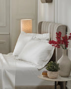Tofu 1000TC sateen king pillow cover set with flange, side view on a made bed