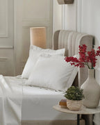 Tofu 1000TC sateen standard pillow cover set with flange, side view on a made bed