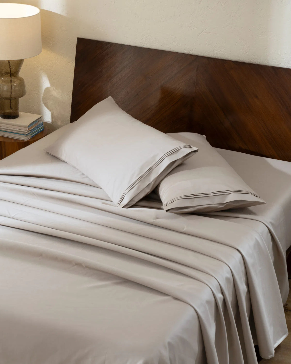 Travertine 1000TC sateen flat and fitted sheet set with king pillow covers, top view on a made bed