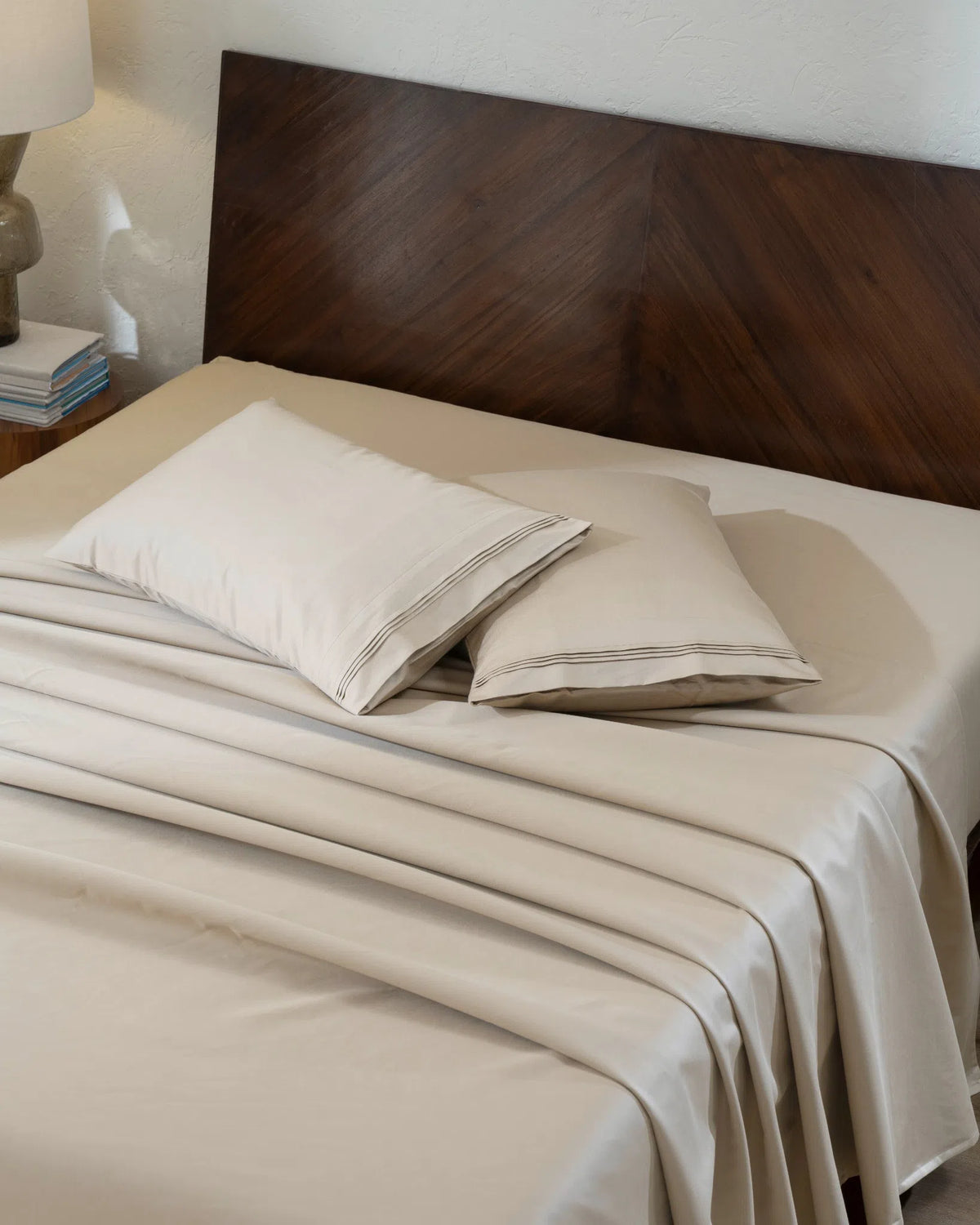 Travertine 1000TC sateen flat and fitted sheet set with standard pillow covers, top view on a made bed