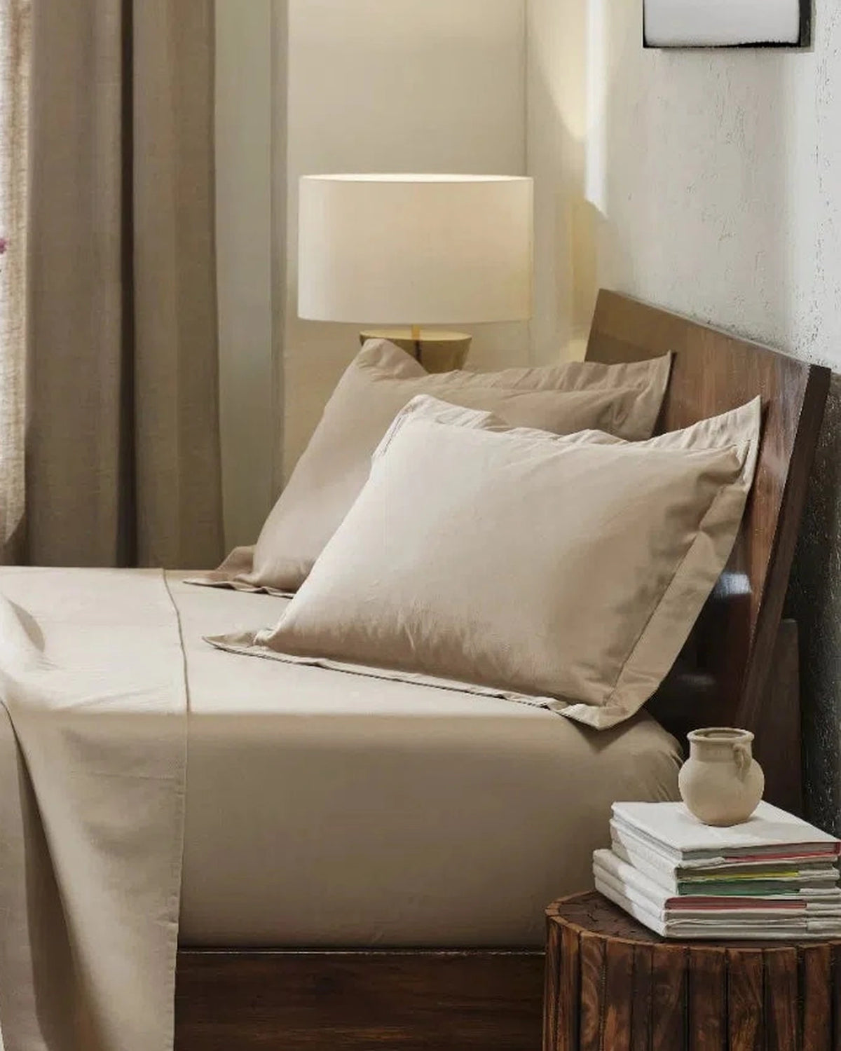 Travertine 1000TC sateen standard pillow cover set with flange, side view on a made bed