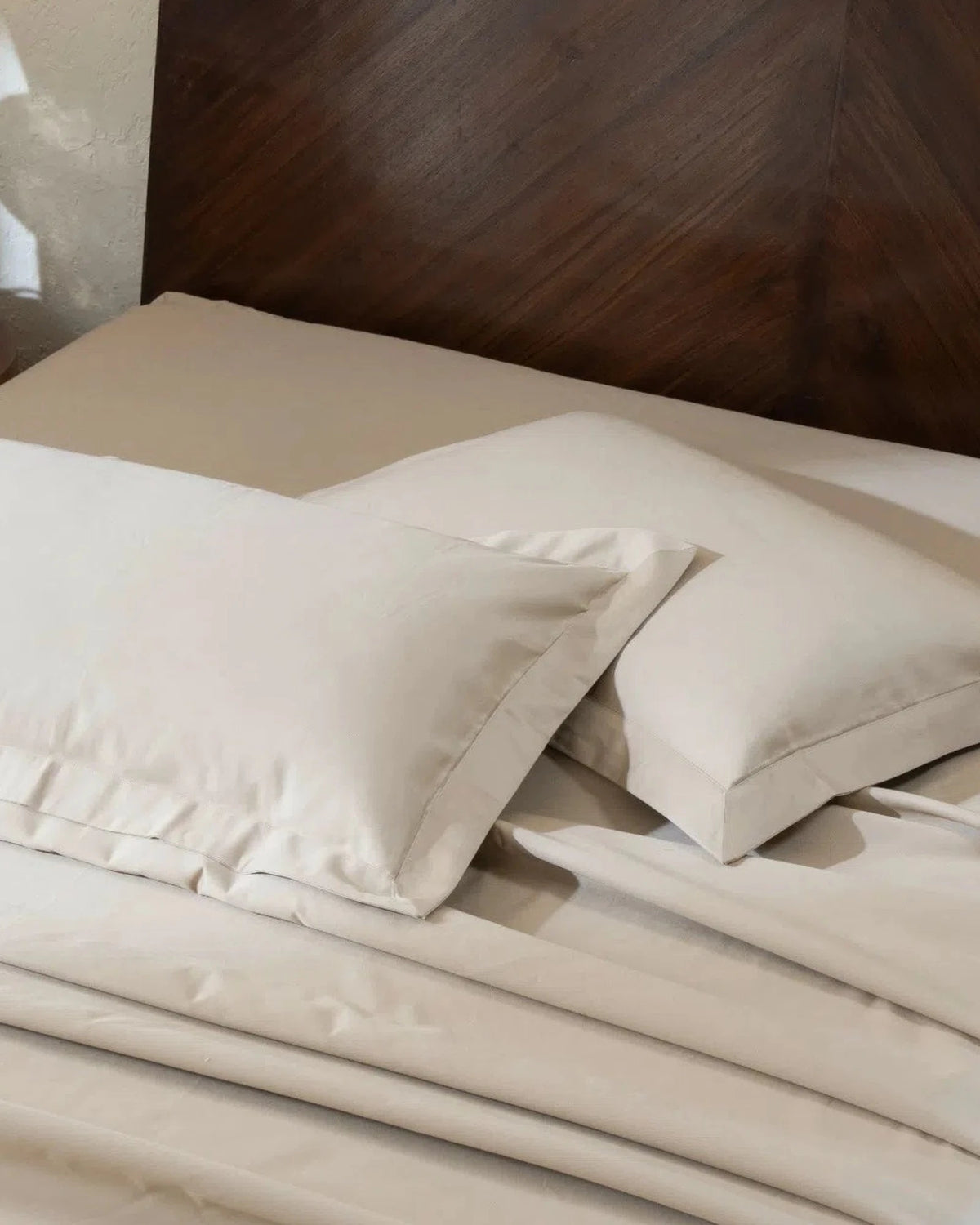 Travertine 1000TC sateen standard pillow cover set with flange, top view on a made bed