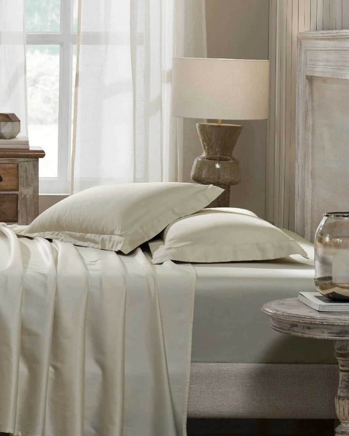 White Sand 600TC sateen standard pillow cover set with flange, side view on a made bed